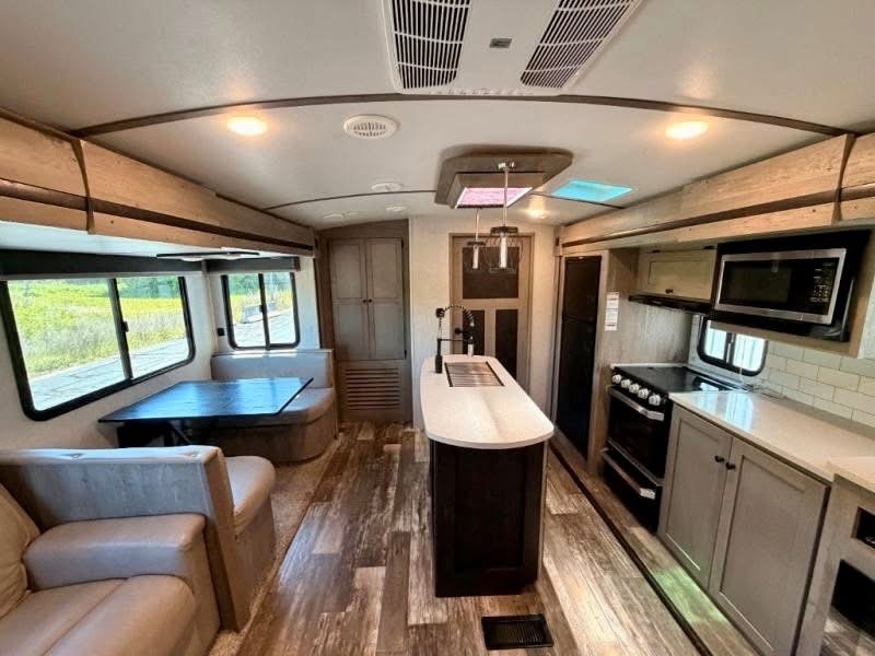 Interior kitchen with island, stove, microwave and dining booth